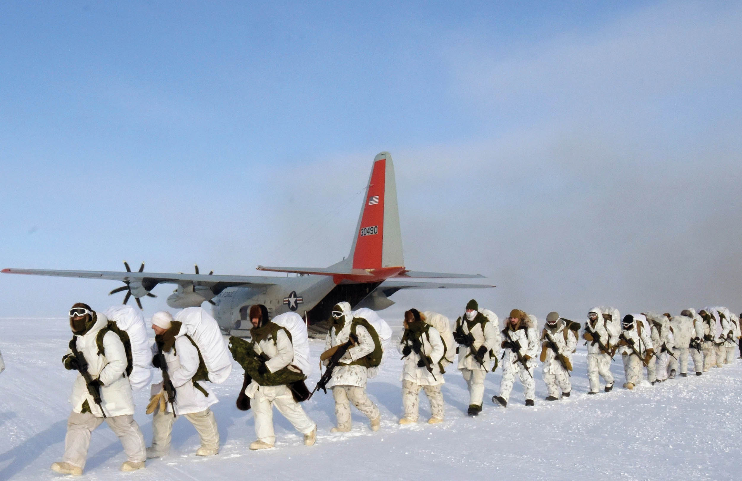 U.S. Army and Canadian soldiers practice and conduct tactical insertion on open ice skiway delivered by ski-equipped LC-130 Hercules of 109th Airlift Wing, New York Air National Guard, on frozen oceanic Arctic ice near Cornwallis Island, Nunavut, Canada, March 15, 2023, as part of exercise Guerrier Nordique 23 (U.S. Army/Mikel Arcovitch)
