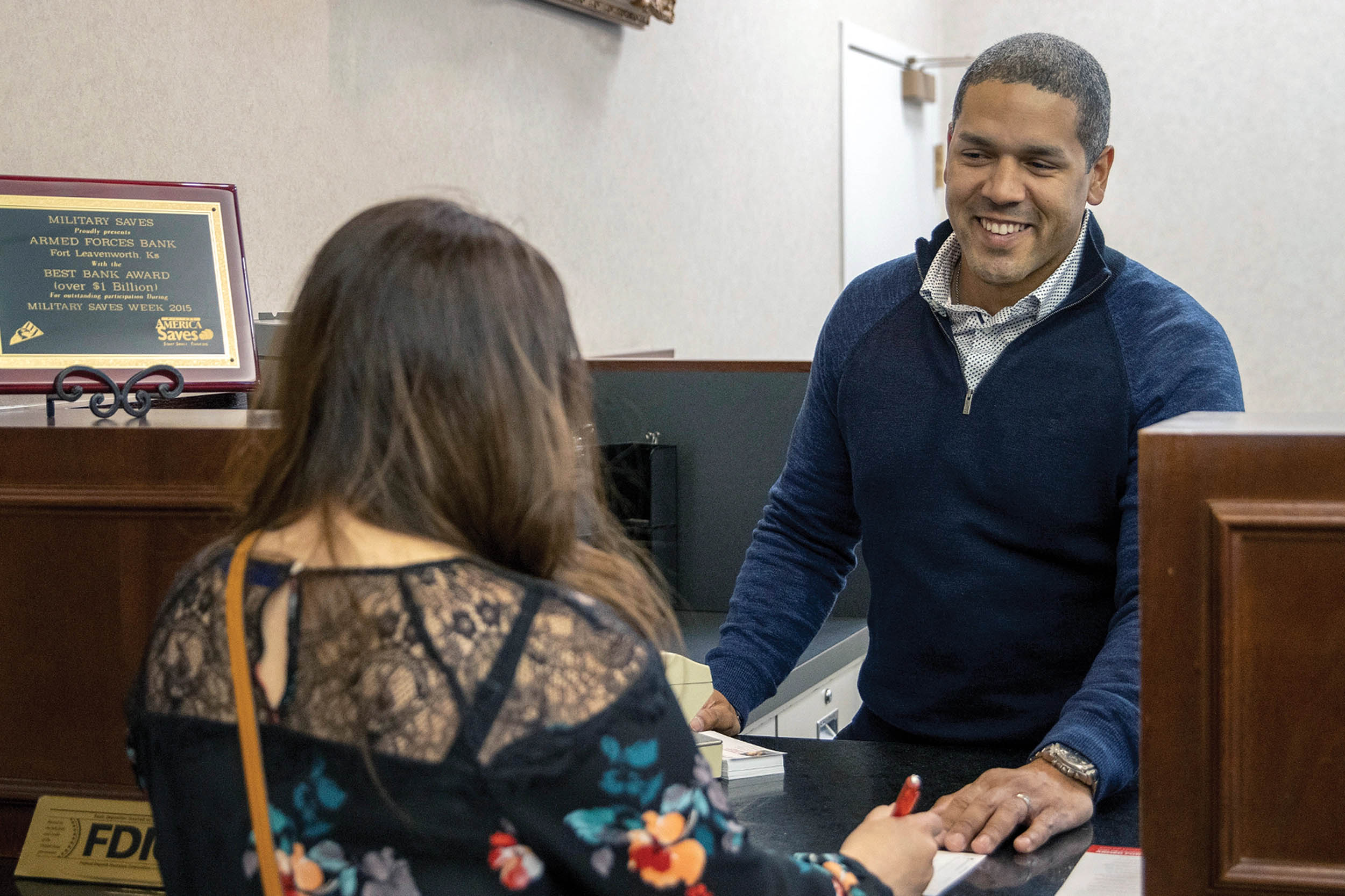 Army Captain Pablo Mendez Adorno, Training With Industry banking officer student, helps customer at Armed Forces Bank, Fort Leavenworth,
Kansas, March 23, 2022 (U.S. Army/Mark R.W. Orders-Woempner)