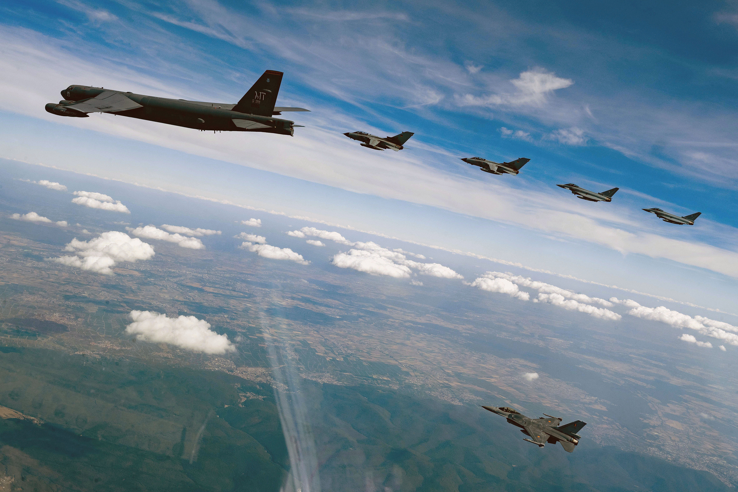 U.S. Air Force 23rd Bomb Squadron B-52H Stratofortress, two German air force Panavia Tornados followed by two German air force Eurofighter Typhoons, and one Belgian air force F-16 Fighting Falcon fly in formation over Germany during Bomber Task Force mission