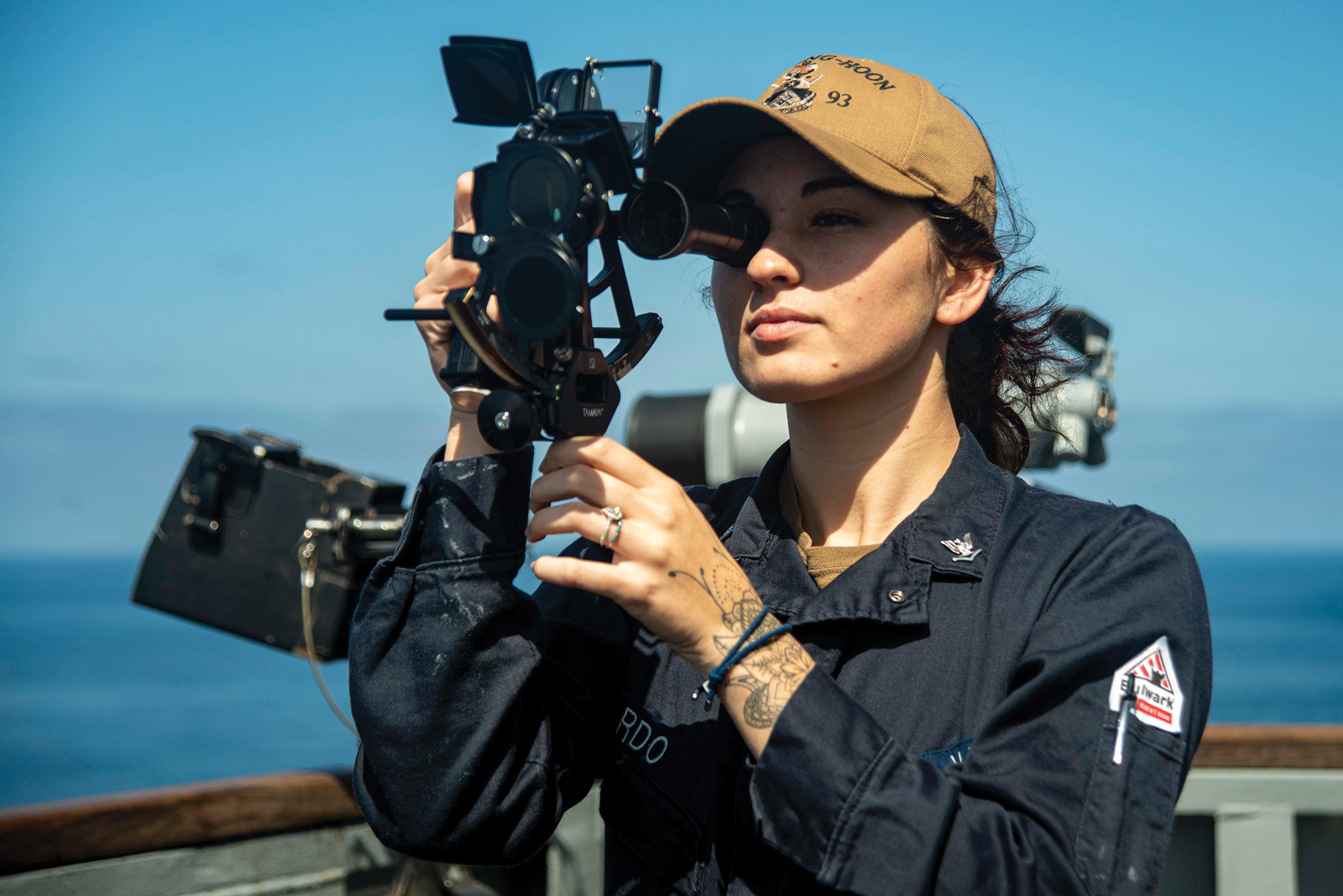U.S. Navy Quartermaster 3rd Class Hailey Pardo shoots sunlines with sextant aboard USS Chung-Hoon