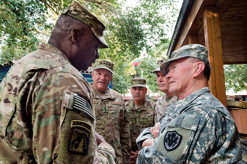 Chairman speaks with U.S. military officers before ISAF and U.S. Forces–Afghanistan change of command ceremony August 26, 2014, in Kabul, during which Marine Corps General Joseph F. Dunford, Jr., relinquished command to Army General John F. Campbell (DOD/Sean K. Harp)