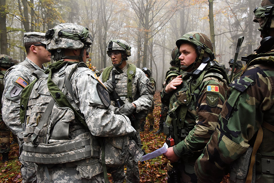 First Brigade Combat Team, 1st Cavalry Division, Soldiers review attack plan with Moldovan soldiers before situational training exercise at Hohenfels Training Area, Germany, October 2014 (U.S. Army/Sarah Tate)