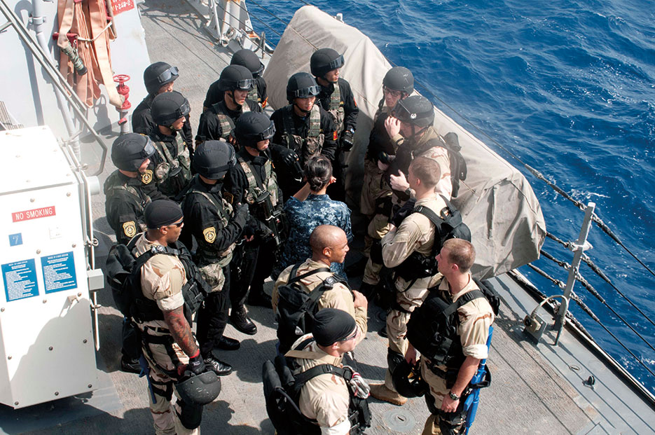 U.S.-China combined visit, board, search, and seizure team, comprised of Sailors from USS Winston S. Churchill and Chinese People’s Liberation Army Navy frigate Yi Yang, holds briefing aboard Winston S. Churchill during bilateral counterpiracy exercise (U.S. Navy/Aaron Chase)
