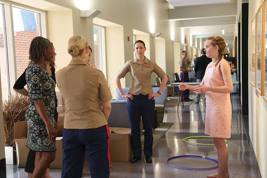 Officer Candidate School instructor explains objective of teambuilding exercise including Marine Corps leadership traits, decisionmaking, and ethical leadership to students from University of North Carolina, at Marine Corps Leadership Seminar, April 2013 (U.S. Marine Corps/Megan Angel)