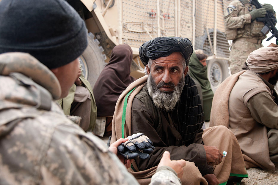 Human Terrain System member speaks with Afghan during Key Leader Engagement in Kandahar Province to discourage locals from hiding contraband for Taliban (DOD/Crystal Davis)