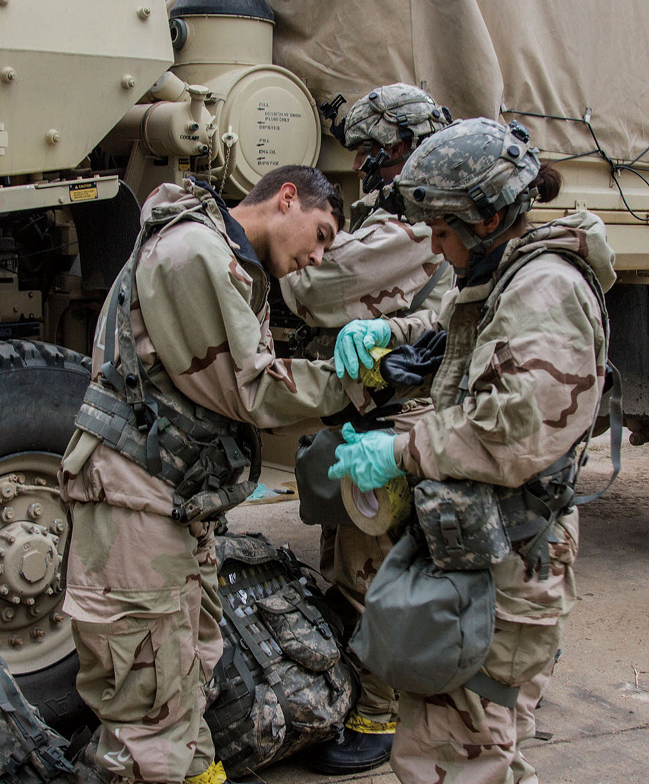 Specialists prepare to investigate mock chemical weapons inside training village of Sangari at Joint Readiness Training Center, Fort Polk, Louisiana (40th Public Affairs Directorate/William Gore)