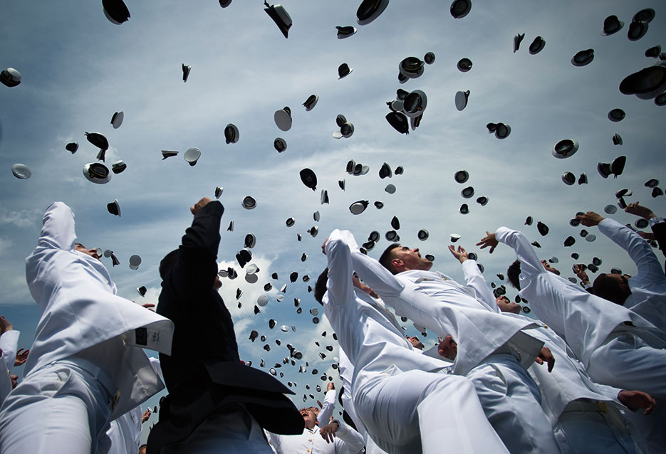 Newly commissioned Navy ensigns and Marine Corps 2<sup>nd</sup> lieutenants from 2011 U.S. Naval Academy class celebrate graduation with traditional hat toss at Navy–Marine Corps Memorial Stadium (U.S. Navy/Kevin S. O’Brien)