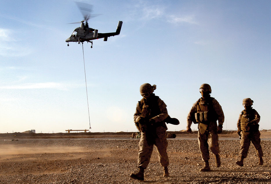 Marines with Combat Logistics Battalion 5 return after learning about downward thrust of Kaman K1200 (“K-MAX”) unmanned helicopter during initial testing in Helmand Province, Afghanistan (U.S. Marine Corps/Lisa Tourtelot)