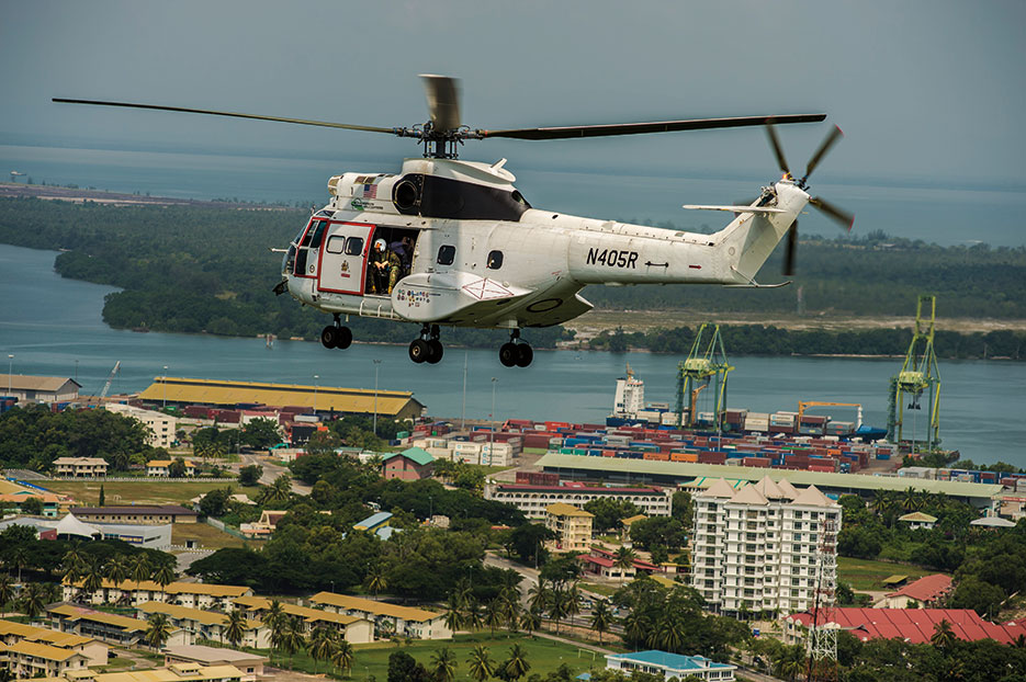 Helicopter assigned to USNS <i>Matthew Perry</i> (T-AKE-9) transports personnel to medical exchange during Association of Southeast Asian Nations Humanitarian Assistance/Disaster Relief and Military Medicine Exercise, hosted by Brunei, June 2013 (U.S. Navy/Paul Seeber)