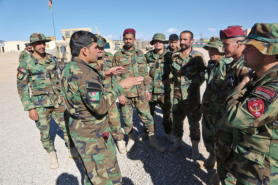 Afghan commando noncommissioned officer gives instruction to junior enlisted commandos at Foreign Internal Defense training in Uruzgan Province, Afghanistan, March 2013 (U.S. Army/Wes Conroy)