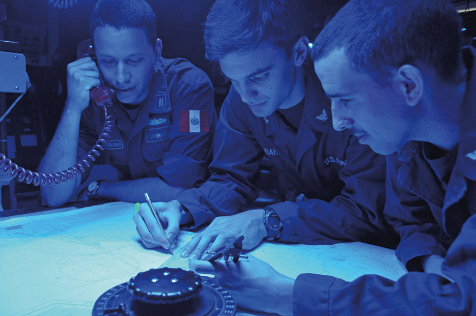 Two U.S. Navy Sailors and Peruvian sailor confirm position of simulated enemy destroyer in combat information center aboard guidedmissile frigate USS Rentz during wargames as part of annual UNITAS multinational maritime exercise, off coast of Colombia, September 14, 2013 (U.S. Navy/Corey Barker)
