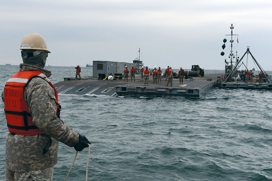 Soldier assigned to 331st Transportation Company works to bring last sections of Trident causeway together during Combined Joint Logistics Over-the-Shore military exercise on the Korean Peninsula, April 18–28, 2013 (U.S. Navy/Anthony R. Hayes)