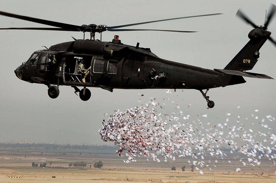 Soldiers from U.S. Army’s 350th Tactical Psychological Operations, 10th Mountain Division, drop leaflets over village near Hawijah, Iraq, on March 6, 2008, promoting idea of self-government (U.S. Air Force/Samuel Bendet)