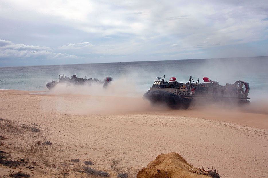 Landing craft air cushions transport U.S. Marines and Portuguese marines from the USS Arlington Kearsarge Amphibious Ready Group toward Pinheiro Da Cruz beach to participate in combined amphibious assault exercised as part of Trident Juncture 15, October 20, 2015 (U.S. Marine Corps/Jeraco Jenkins)
