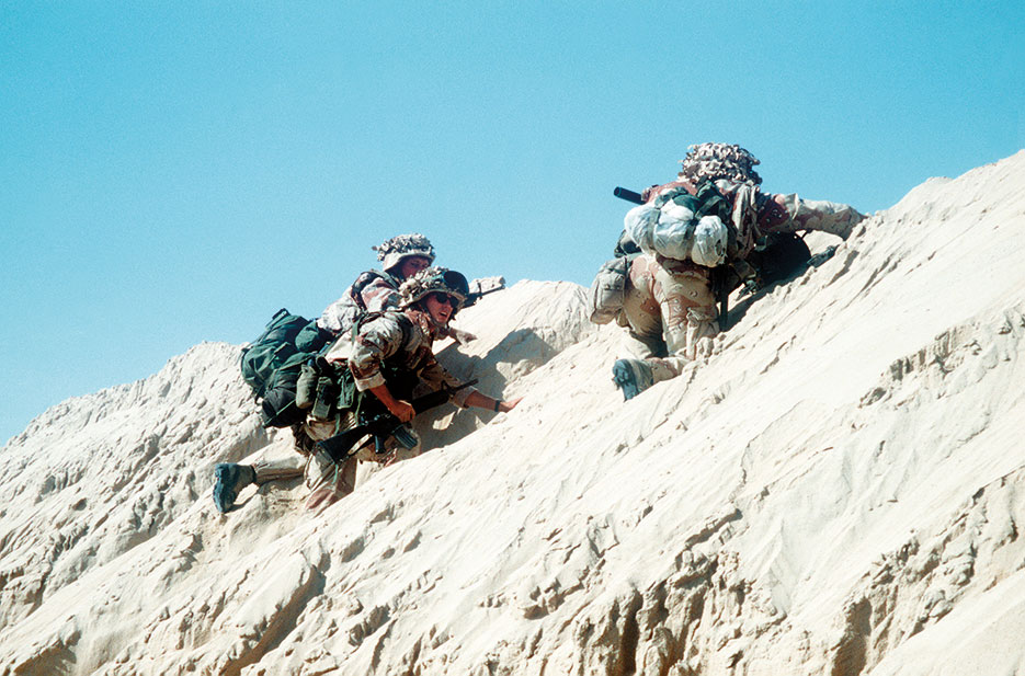 Marines climb side of berm into attack positions during Operation Desert Storm (U.S. Marines/R.J. Engbrecht)