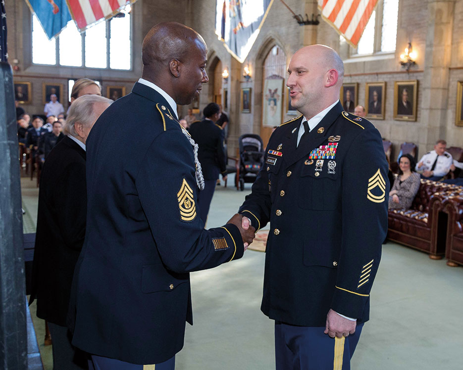 Sergeant 1st Class John Wesserling receives congratulatory handshake from Command Sergeant Major David M. Clark during inaugural Benavidez Leader Development Program graduation ceremony in Thayer Award Room at West Point (U.S. Army/Vito T. Bryant)