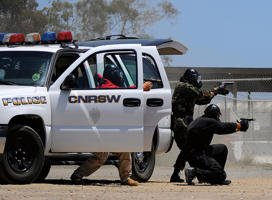 Sailors and Federal law enforcement personnel conduct live-fire training during Navy Security Forces Training Course pilot program, training civilian and military police forces to work together, June 23, 2010, San Diego (U.S. Navy/AC Rainey)