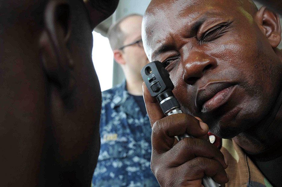 Member of Cameroonian Battalion d’Intervention Rapide gives eye exam with equipment provided by U.S. Navy during healthcare workshop as part of Africa Partnership Station 2013, Douala, Cameroon, March 27, 2013 (U.S. Army/Jeffrey Hernandez)