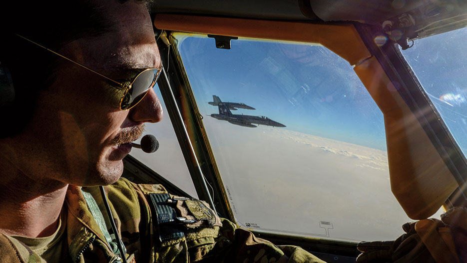 Captain Timothy Black pilots KC-135 Stratotanker on combat refueling mission over Southwest Asia while two Navy F/A-18C Hornets fly alongside, May 21, 2017 (Air National Guard/Andrew J. Moseley)