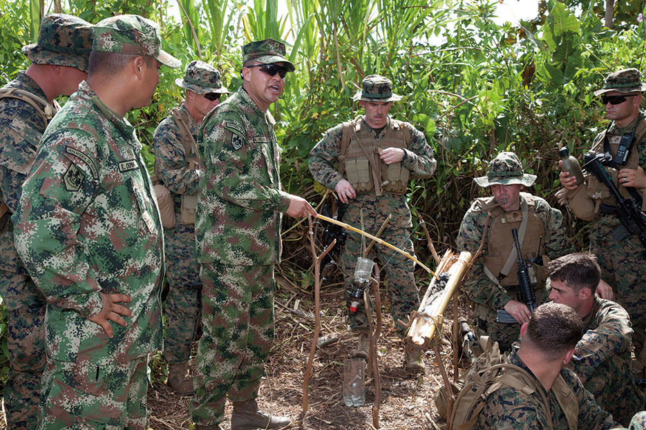 Colombian naval infantrymen explain their water purification and jungle survival techniques to U.S. Marines during Amphibious-Southern Partnership Station near Turbo, Colombia, October 10, 2011 (U.S. Army/Juancarlos Paz)