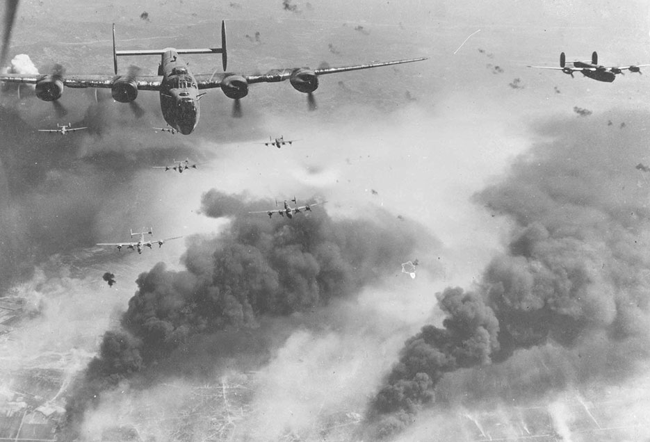 Through flak and over destruction created by preceding waves of bombers, 15th Air Force B-24 Liberators leave Ploesti, Rumania, after one of long series of attacks against primary oil target in Europe, August 1, 1943 (U.S. Air Force/Jerry J. Jostwick)