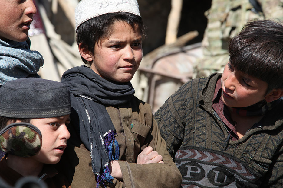 Local boys observe activity within village of Sharmai, Paktika Province, Afghanistan, February 18, 2013, as Human Terrain Teams speak with locals (U.S. Army/Raymond Schaeffer)