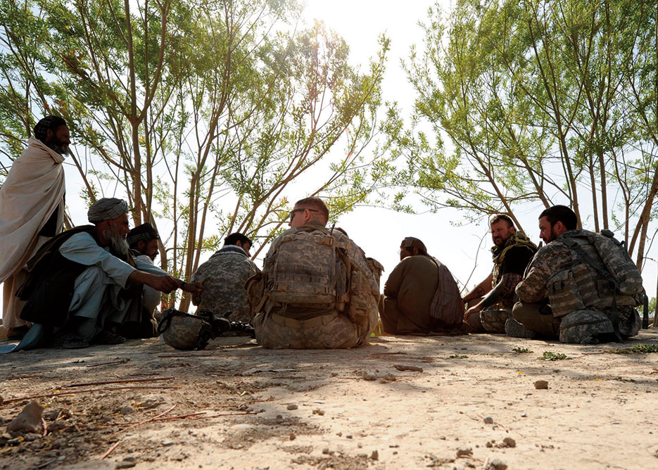 Human Terrain Team consisting of U.S. Army Soldiers and civilians, along with Afghan interpreter, meet with local citizens of village near Kandahar Air Field, Afghanistan (U.S. Army/Stephen Schester)