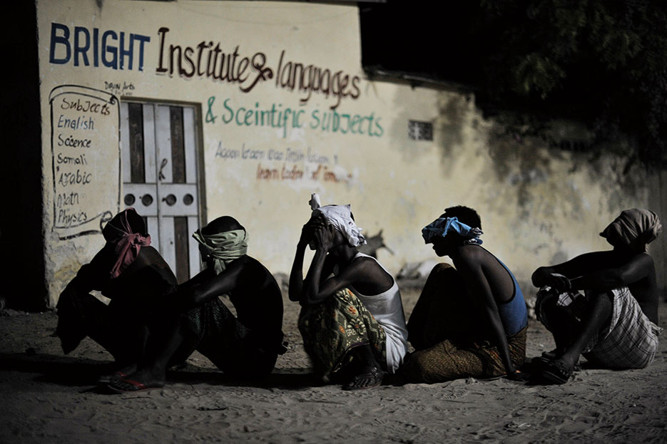 Suspected al Shabab militants wait to be taken away for interrogation during joint night operation between Somali security services and African Union Mission in Somalia forces in Mogadishu, Somalia, May 4, 2014 (Courtesy UN Photo/Tobin Jones)