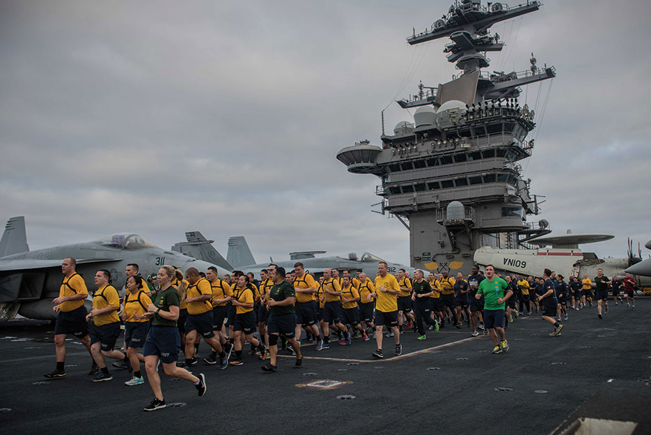 Chief selects run in formation during Applied Suicide Intervention Skills Training 5k run on flight deck of aircraft carrier USS Theodore Roosevelt, August 17, 2017 (U.S. Navy/Alex Perlman)