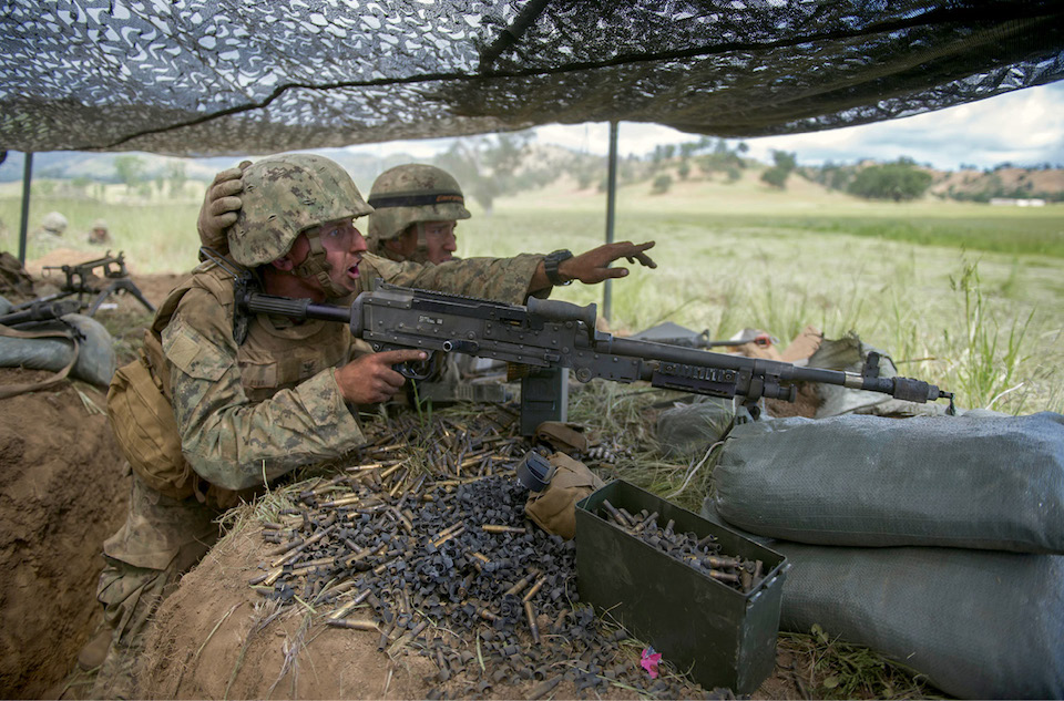Seabee, assigned to Naval Mobile Construction Battalion 5, yells out enemy locations in simulated attack during field training exercise, Fort Hunter Liggett, California, April 27, 2016 (U.S. Navy/Stephen Sisler)