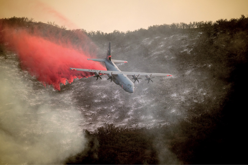 U.S. Air National Guard C-130J Hercules aircraft equipped with Modular Airborne Fire Fighting System drops line of fire retardant on Thomas Fire in hills above city of Santa Barbara, California, December 13, 2017 (U.S. Air National Guard/Nieko Carzis)