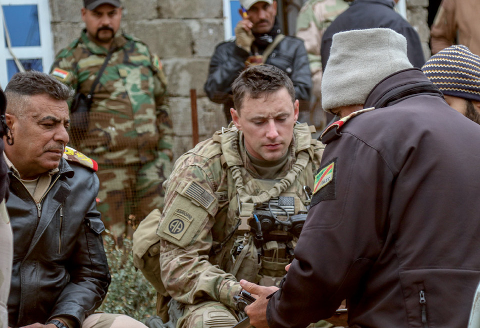 U.S. Soldier deployed in support of CJTF–Operation Inherent Resolve discusses operations with 9th Iraqi army division leaders during offensive to liberate West Mosul from Islamic State, near Al Tarab, Iraq, March 19, 2017 (U.S. Army/Jason Hull)