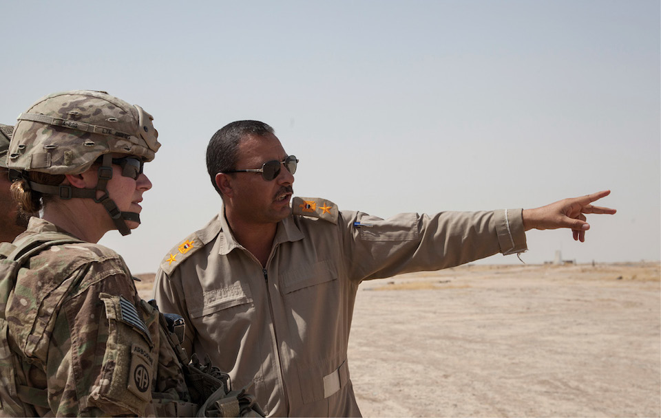 Iraqi soldier speaks with commanding officer of 407th Brigade Support Battalion, 2nd Brigade Combat Team, 82nd Airborne Division, deployed in support of CJTF–Operation Inherent Resolve, near Qayyarah West Airfield, Iraq, July 23, 2017 (U.S. Army/Rachel Diehm)