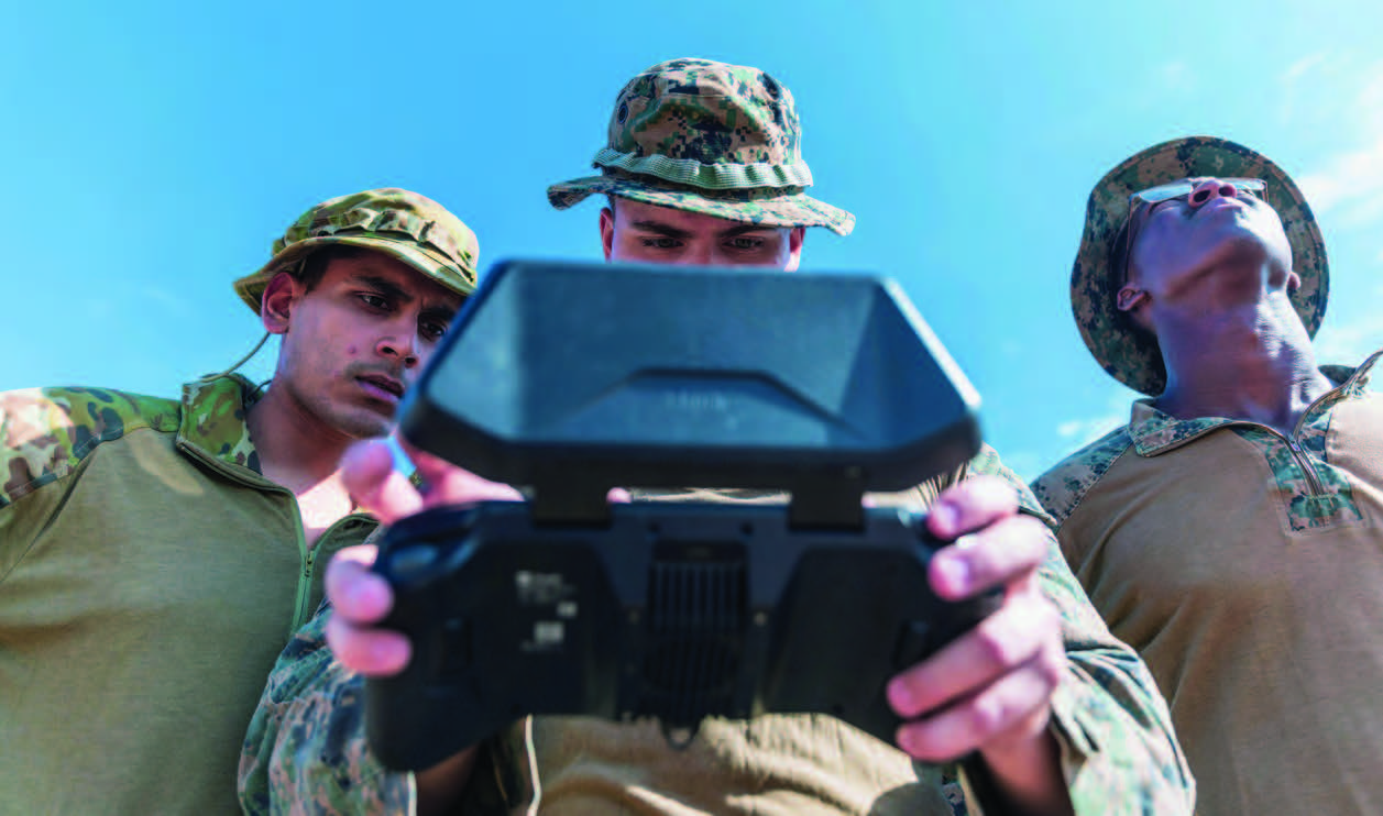 Lieutenant Tushar Madan, left, U.S. Navy exchange officer to Australia’s Headquarters Joint Operations Command J2 branch; U.S. Marine Corps Corporal Brian Vile, center, intelligence specialist; and Corporal Salmon Shaedon, assistant forecaster, both with Marine Rotational Force– Darwin 24.3, operate Skydio drone as part of counter–unmanned aircraft systems field test at Mount Bundey Training Area, Northern Territory, Australia, July 11, 2024 (U.S. Marine Corps/Migel A. Reynosa)