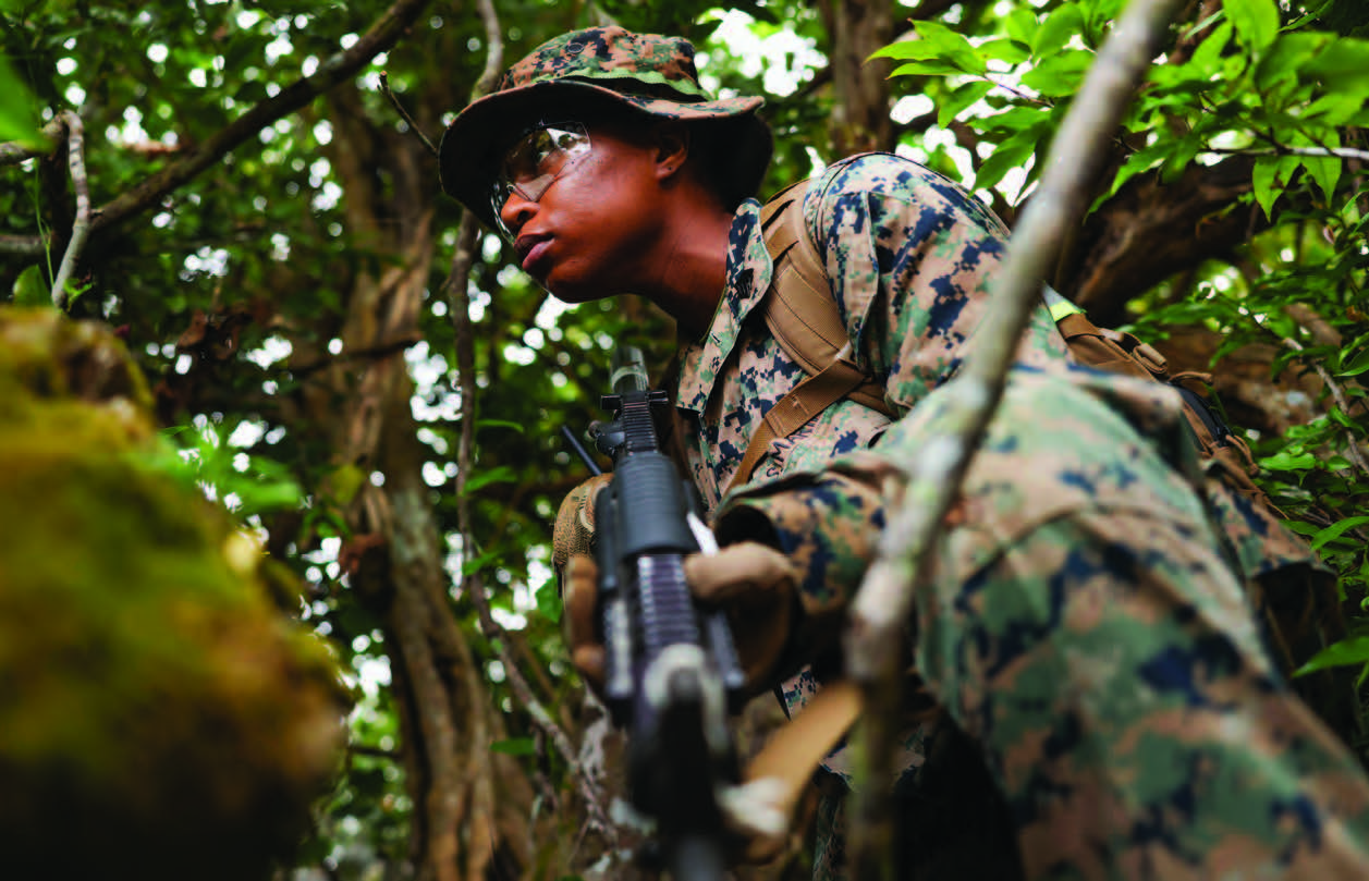 Marine Corps Sergeant Andrea Rosembert posts security during halt on training patrol at Andersen Air Force Base, Guam, March 15, 2024 (U.S. Marine Corps/Ryan Little)