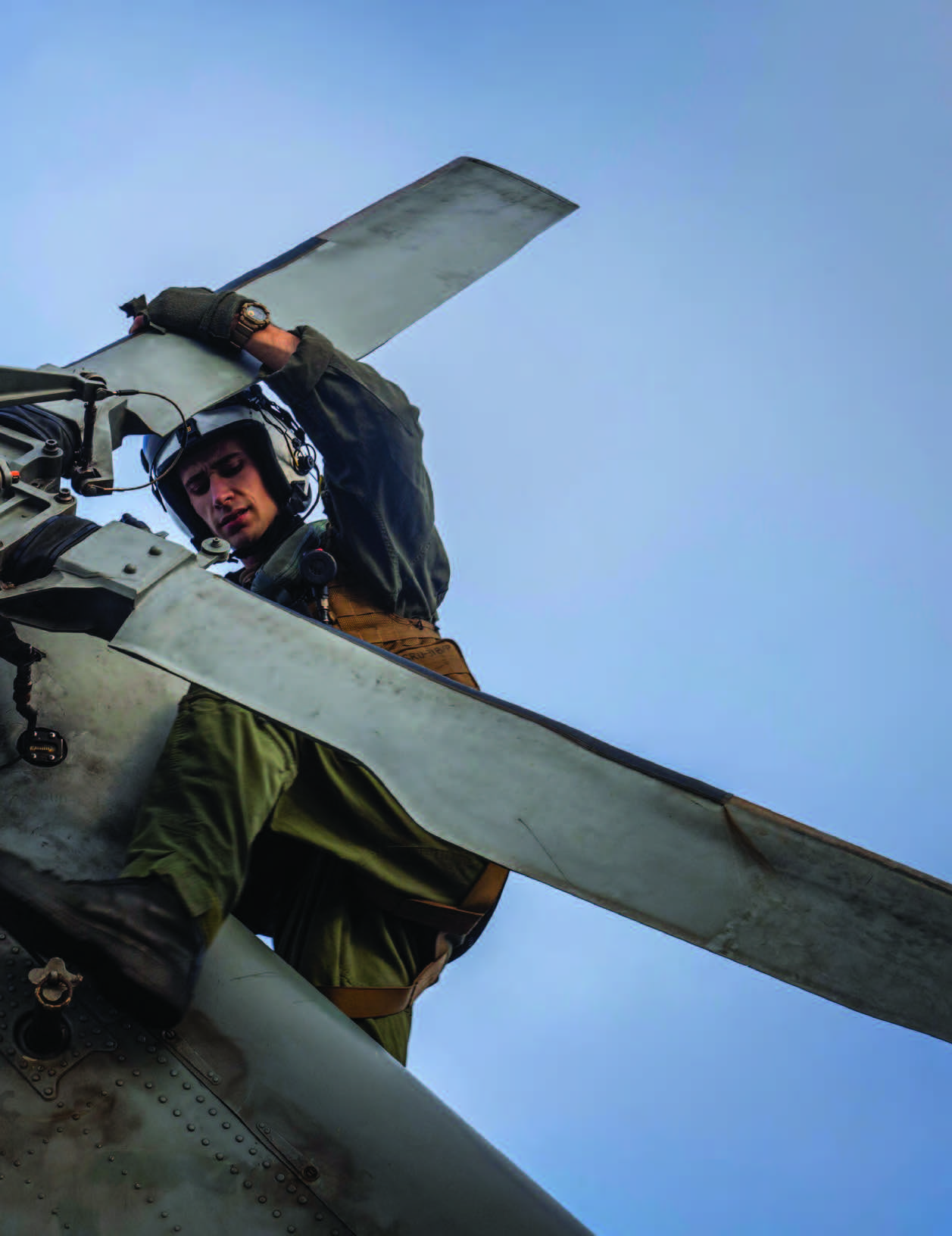 Naval Aircrewman (Helicopter) 3rd Class Michael Case conducts preflight checks on MH-60S Sea Hawk helicopter assigned to “Black Knights” of Helicopter Sea Combat Squadron 4 while underway operating with USS Carl Vinson in Pacific Ocean, August 13, 2024 (U.S. Navy/Kenneth Ostas)