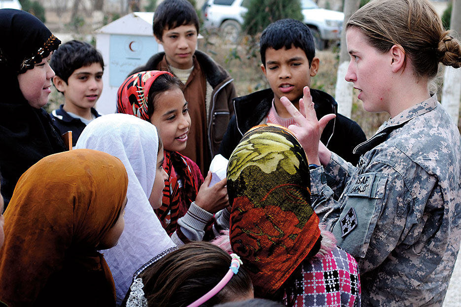 1st Lt. Rebecca Wagner, USA, effects coordinator and Female Engagement Team officer in charge, counts with Afghan children of the Red Crescent Society orphanage and school (U.S. Army/Jeanita C. Pisachubbe)