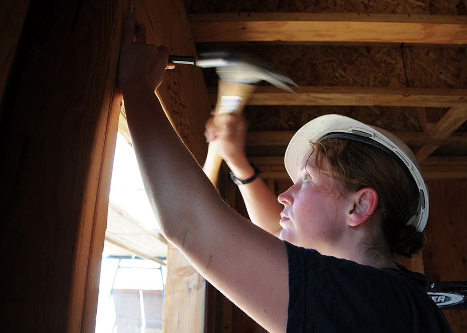 Cryptologic Technician (Technical) 2<sup>nd</sup> Class Lisa Quincy working at Habitat for Humanity project in Lawndale, California, supported by volunteer efforts of several USS <i>Abraham Lincoln</i> (CVN 72) Sailors (U.S. Navy/Zachary A. Hunt)