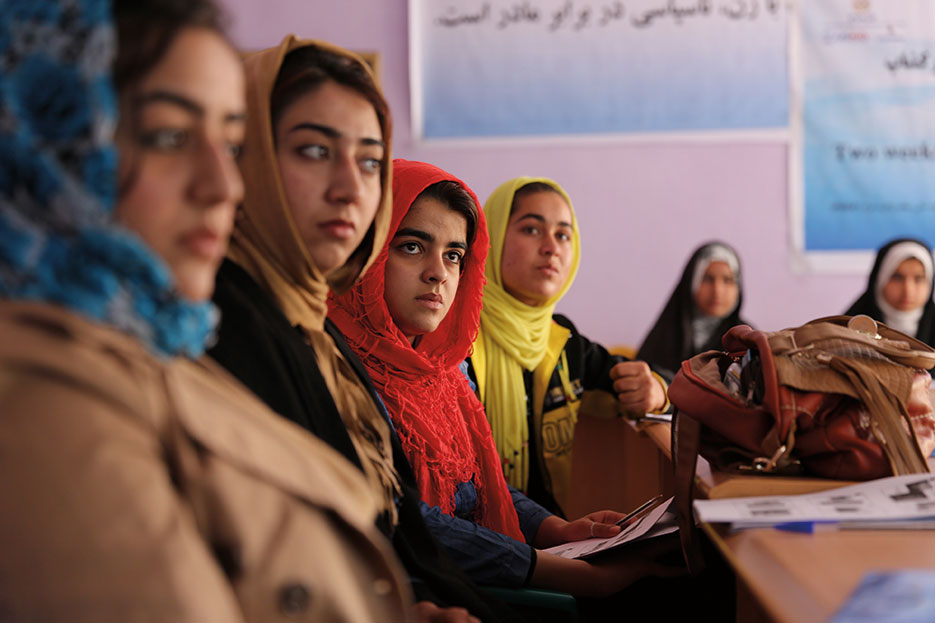 Farahi journalists listen to discussion about photo composition during training at Directorate of Women’s Affairs building in Farah City, Afghanistan, February 2013 (U.S. Navy/Josh Ives)