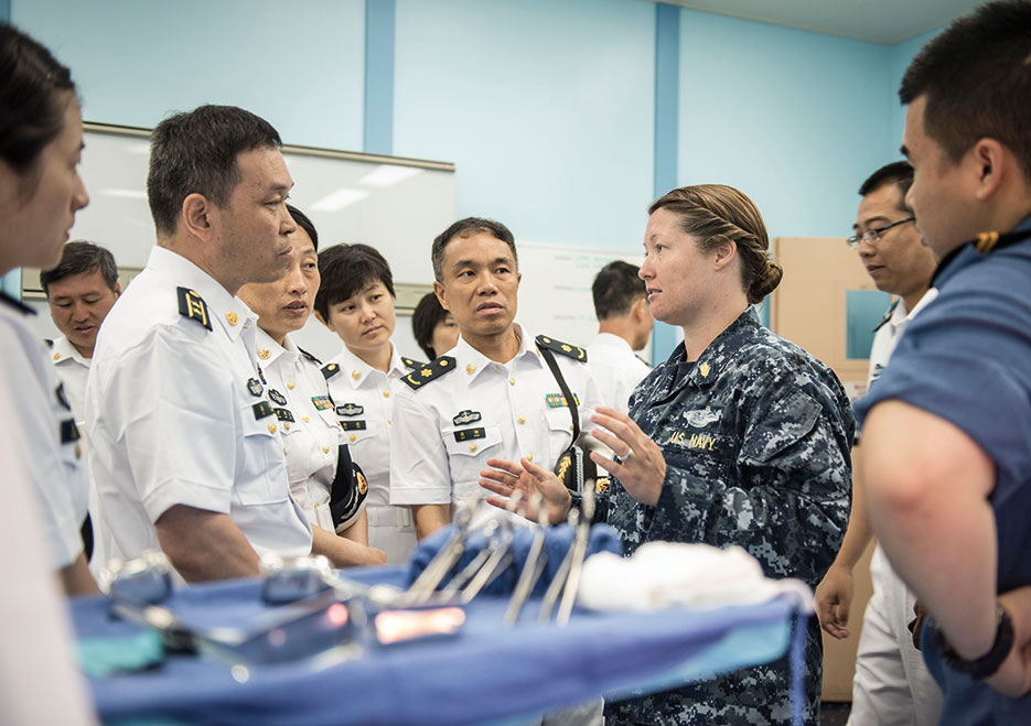 Lieutenant Jessica Naranjo, USN, speaks to People’s Liberation Army Navy medical personnel from hospital ship <i>Peace Ark</i> (T-AH 866) during tour of Military Sealift Command hospital ship USNS <i>Mercy</i> (T-AH 19) (U.S. Navy/Justin W. Galvin)